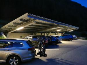 a parking lot with cars and a bike parked in it at Hotel Garni Schönblick in Sölden