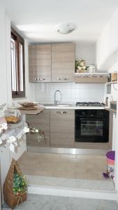 a kitchen with a sink and a stove at Mamma Rosa in Trecase