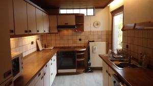 a kitchen with a sink and a stove top oven at Casa la Collina delle Ginestre in Eberbach