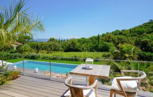 a patio with a table and chairs and a swimming pool at villa Sant-Anna in Saint-Tropez