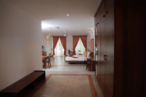 een slaapkamer met een bed en een woonkamer bij Refresh Hotel Hikkaduwa in Hikkaduwa