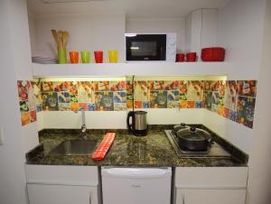 a kitchen counter with a sink and a stove at Departamento Céntrico con Vista in San Carlos de Bariloche