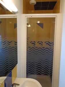 a bathroom with a shower and a sink at Appartement d'Hôtes in Guéret