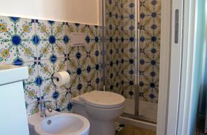 a bathroom with a toilet and a shower and a sink at Valente rooms in Agropoli