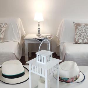 a white room with a bed and a table with two chairs at Eirinaki House in Patmos