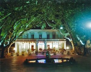 a white house with a large tree in front of it at La Piccola Oasi Toscana in Bagni di Lucca