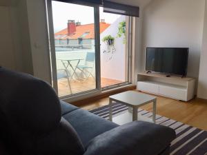 Telewizja i/lub zestaw kina domowego w obiekcie Portosín -Suites