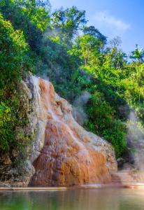 a waterfall on the side of a river at Termales Santa Rosa De Cabal in Santa Rosa de Cabal +103 photos