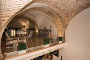 a room with a guitar and a table and chairs at Lost Inn Lisbon Hostel in Lisbon