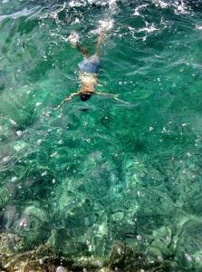 a person is swimming in the water at Novalja centar in Novalja