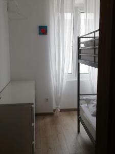 a bedroom with a bunk bed and a window at Novalja centar in Novalja