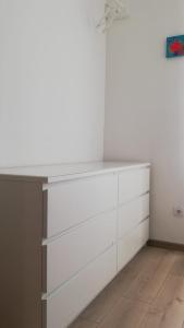 a white dresser in a room with white cabinets at Novalja centar in Novalja +16 photos