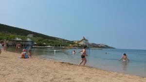 a group of people playing in the water on a beach at Novalja centar in Novalja