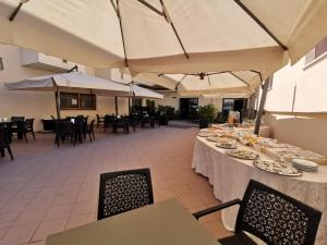 a table with plates of food on it in a restaurant at Hotel Calgary in Casalbordino +17 photos