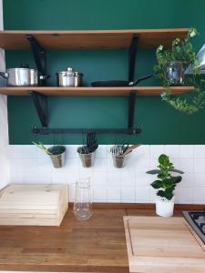 a kitchen with pots and pans on a shelf at Guesthouse Prusa 7 in Oświęcim