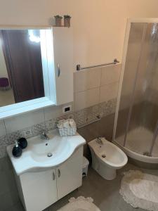 a bathroom with a sink and a shower and a toilet at Appartamento La Sicula in Realmonte +19 photos