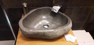 a large stone sink sitting on a counter in a bathroom at A 2 PASSI da in Foggia