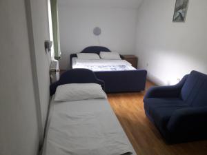 Šipovo的住宿－Motel Tetrijeb Sipovo，一间设有两张床、一张沙发和一把椅子的房间