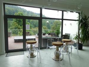 a room with two tables and chairs and a patio at Mazowsze Medi Spa in Ustroń