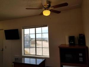 a living room with a ceiling fan and a window at 071A Private Studio near South Rim Sleeps 6- No Kitchen in Valle