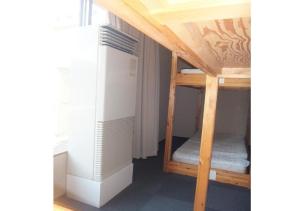 a small room with two bunk beds in it at Hidamarinoyu mix dormitory / Vacation STAY 40392 in Takayama