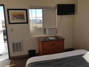 a bedroom with a bed and a dresser and a window at 068D Cozy Studio Grand Canyon South Rim Sleeps-2 in Valle