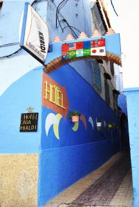 a blue wall with a toy train on it at Hotel Casa Khaldi in Chefchaouen