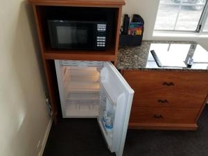 a small refrigerator with a microwave in a kitchen at 072B Affordable Retreat nr South Rim Sleeps 4- no kitchenette in Valle
