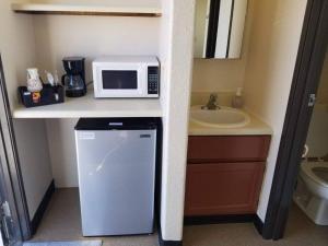a kitchen with a refrigerator and a microwave on a counter at 068A Cozy Studio Grand Canyon South Rim Sleeps-2 in Valle