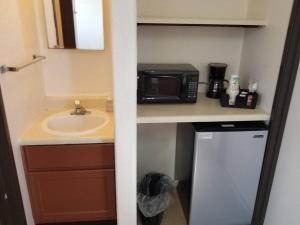a small kitchen with a sink and a microwave at 068B Cozy Studio Grand Canyon South Rim Sleeps-2 in Valle