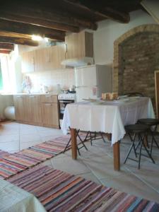 a kitchen with a table with a white table cloth on it at RIVER HOUSE MARIA in Lefkimmi +13 photos