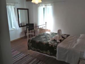 a bedroom with a bed with a robe on it at RIVER HOUSE MARIA in Lefkimmi