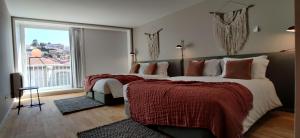 מיטה או מיטות בחדר ב-Oporto Serviced Apartments - Miragaia