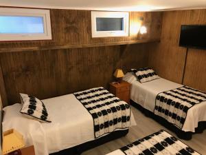 Ένα ή περισσότερα κρεβάτια σε δωμάτιο στο Hotel Luanco