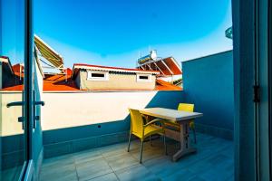 a table and chairs on a balcony with a view of a boat at Belek Akropolis Medusa Otel in Belek