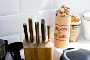 a kitchen counter with a knife block filled with cooking utensils at Bright 2 bedroom Apt - Great location - Free Parking in Bournemouth