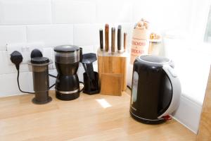 a kitchen counter with a coffee maker and utensils at Bright 2 bedroom Apt - Great location - Free Parking in Bournemouth
