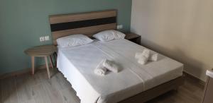a bedroom with a bed with two towels on it at Chriselia 1 in Nea Roda