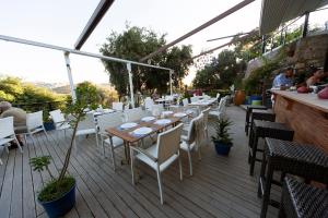 a restaurant with a table and chairs on a deck at Metins Gümüşlük in Bodrum City
