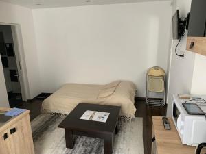 a small room with a bed and a table at Luxury Accommodation Republicii in Braşov
