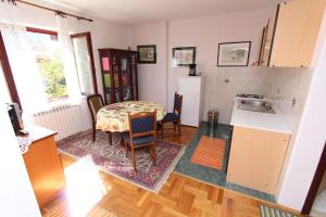 a kitchen with a table and a kitchen with a table and a refrigerator at Apartments Grace in Rovinj