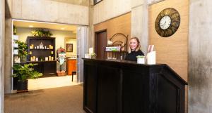 a woman sitting at a counter in a store at Alta's Rustler Lodge in Alta +54 photos