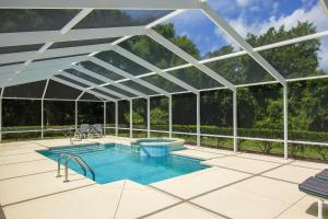 a swimming pool with a glass roof on a patio at North Timucuan Trail Villa 1208 in Hernando