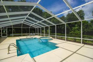an overhead view of a swimming pool in a glass house at North Timucuan Trail Villa 1208 in Hernando