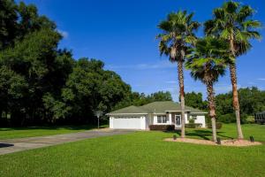 a house with two palm trees in front of it at North Timucuan Trail Villa 1208 in Hernando +36 photos