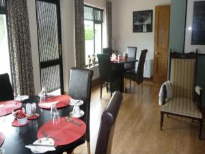 a dining room with a table and a table and chairs at Carrigshane House in Midleton