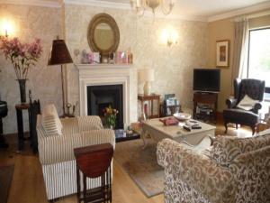 a living room filled with furniture and a fireplace at Carrigshane House in Midleton