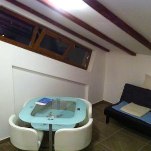 a room with a blue table and a couch at Delfin in Novigrad Istria