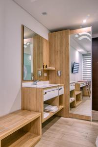 a bathroom with a sink and a mirror at Hotel Dix in Medellín
