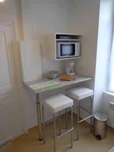 TV i/ili multimedijalni sistem u objektu Appartement d'Hôtes